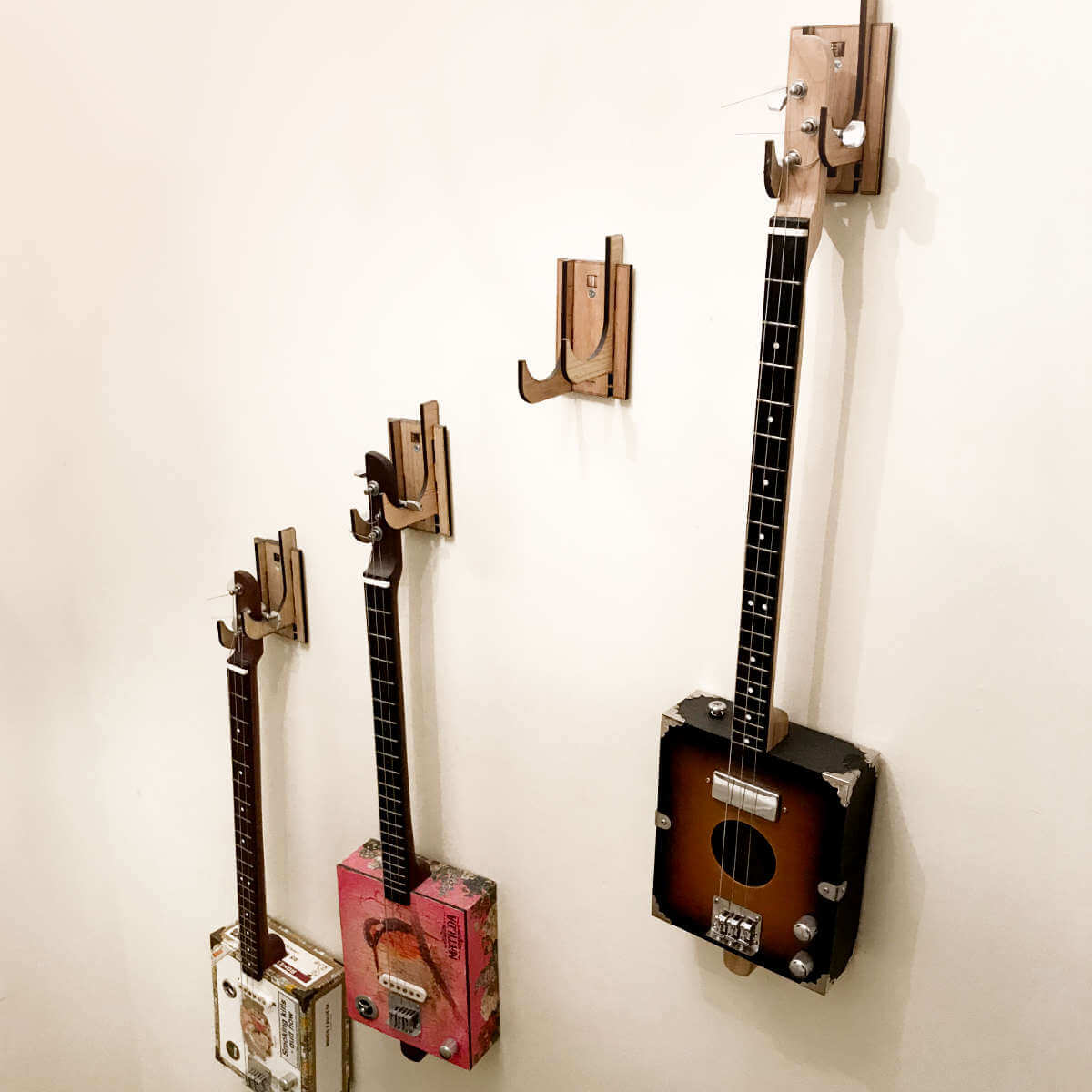 Cigar Box Guitars on Wall Hangers